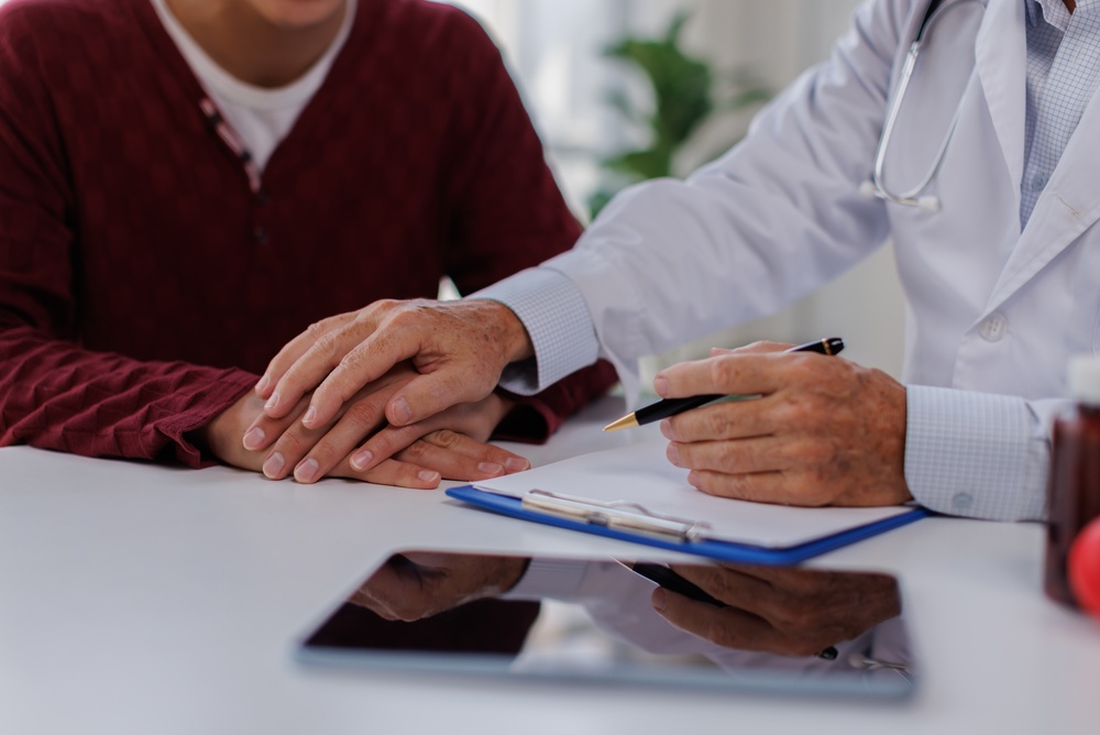 doctor comforting patient over cost of abortion procedures in Teaneck