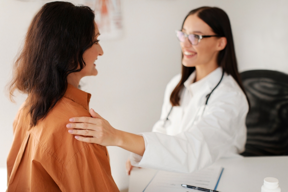 woman comforted before cervical cancer screening in Englewood